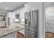 Stainless refrigerator in the kitchen alongside white cabinets and granite countertops at 2341 Shiny Leaf Dr, Denver, NC 28037