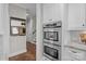 Stainless steel double ovens in the kitchen alongside built-in organizers and white cabinetry at 2341 Shiny Leaf Dr, Denver, NC 28037