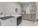 Functional laundry room features modern appliances, storage cabinets, and a butcher block countertop at 2341 Shiny Leaf Dr, Denver, NC 28037