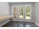 Bright home office featuring polished concrete floors, a simple desk, and three large windows with green views at 2341 Shiny Leaf Dr, Denver, NC 28037
