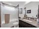 Well-lit bathroom with a granite countertop vanity, framed mirror, and shower with glass doors at 246 Bushney Loop, Mooresville, NC 28115