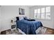 Bright bedroom with a comfortable bed, stylish rug, and white plantation shutters at 246 Bushney Loop, Mooresville, NC 28115