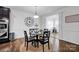 Eat-in dining area with wood floors and wainscotting detail leading to the kitchen and sunroom at 246 Bushney Loop, Mooresville, NC 28115