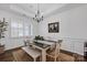 Elegant dining room with wainscoting, chandelier, and a large window with plantation shutters at 246 Bushney Loop, Mooresville, NC 28115