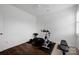 Bright exercise room featuring hardwood floors, an exercise bike, weights, and a mini-trampoline at 246 Bushney Loop, Mooresville, NC 28115