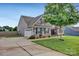 Charming home featuring stone accents, a two-car garage, and a well-manicured lawn at 246 Bushney Loop, Mooresville, NC 28115
