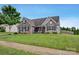 Charming home with stone accents, neat landscaping, and a well-manicured lawn at 246 Bushney Loop, Mooresville, NC 28115