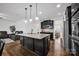 Open kitchen with a center island, granite countertops, stainless appliances and dark wood flooring at 246 Bushney Loop, Mooresville, NC 28115