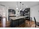 This gourmet kitchen boasts a center island with granite countertops, modern lighting, and sleek stainless appliances at 246 Bushney Loop, Mooresville, NC 28115
