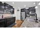 Modern kitchen featuring stainless steel appliances, granite countertops, and dark wood cabinets at 246 Bushney Loop, Mooresville, NC 28115
