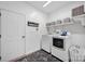 Functional laundry room with modern appliances, shelving, and decorative storage baskets at 246 Bushney Loop, Mooresville, NC 28115