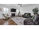 Bright and inviting living room featuring a fireplace, plush seating, and a stylish ceiling fan at 246 Bushney Loop, Mooresville, NC 28115