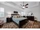 Spacious main bedroom with trey ceilings, ceiling fan, plantation shutters, and dark wood furniture at 246 Bushney Loop, Mooresville, NC 28115