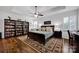 Spacious main bedroom with trey ceilings, ceiling fan, plantation shutters, and dark wood furniture at 246 Bushney Loop, Mooresville, NC 28115