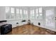 Bright sunroom filled with natural light from the large windows and wood flooring at 246 Bushney Loop, Mooresville, NC 28115