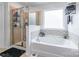 Luxurious bathroom showcasing a soaking tub with mosaic tile accents and a separate glass-enclosed shower at 261 Catoctin Rd, Rock Hill, SC 29732
