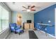 Versatile bonus room is perfect for fitness or recreation with its blue accent wall and ceiling fan at 261 Catoctin Rd, Rock Hill, SC 29732
