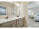 Bathroom with double vanity, white countertop and view into bedroom at 300 Wheatberry Hill Dr, Weddington, NC 28104