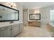 Bathroom featuring double sinks, tile flooring, and a large vanity with great lighting at 300 Wheatberry Hill Dr, Weddington, NC 28104