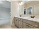 Bright bathroom featuring double sink vanity with updated fixtures and a spacious open doorway to another room at 300 Wheatberry Hill Dr, Weddington, NC 28104