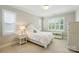 Bright bedroom featuring white bedding, carpet, and shuttered windows at 300 Wheatberry Hill Dr, Weddington, NC 28104