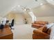 Large bonus room offers a comfortable seating area, workstation, and space for an exercise bike at 300 Wheatberry Hill Dr, Weddington, NC 28104
