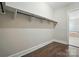 Spacious walk-in closet with custom shelving and storage space with dark wood floor at 300 Wheatberry Hill Dr, Weddington, NC 28104