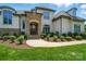Stately home showcasing a stone-accented entrance, well-maintained landscaping, and a welcoming walkway to the front door at 300 Wheatberry Hill Dr, Weddington, NC 28104
