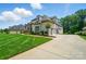 Charming home with a three-car garage and well-manicured lawn, complemented by mature trees and inviting curb appeal at 300 Wheatberry Hill Dr, Weddington, NC 28104