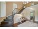 Elegant foyer with curved staircase and hardwood floors, with detailed wrought iron at 300 Wheatberry Hill Dr, Weddington, NC 28104