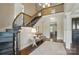 Grand foyer featuring a curved staircase, hardwood floors, and elegant decor, creating a welcoming entrance at 300 Wheatberry Hill Dr, Weddington, NC 28104