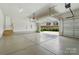 Clean, well lit two-car garage with epoxy flooring and an automatic door opener with access to home at 300 Wheatberry Hill Dr, Weddington, NC 28104
