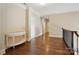 Hallway with gleaming wood floors and white trim at 300 Wheatberry Hill Dr, Weddington, NC 28104