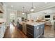 Kitchen island with stainless sink, plentiful storage and hardwood floors at 300 Wheatberry Hill Dr, Weddington, NC 28104