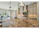 Granite island overlooks custom cabinetry and backsplash at 300 Wheatberry Hill Dr, Weddington, NC 28104