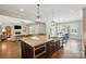 Granite island with stainless appliances overlooks the breakfast nook and living room at 300 Wheatberry Hill Dr, Weddington, NC 28104