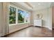 Bright living room with hardwood floors, natural light, and a view of the landscaped yard at 300 Wheatberry Hill Dr, Weddington, NC 28104