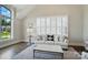 Bright living room with white couch, large shuttered window and natural light at 300 Wheatberry Hill Dr, Weddington, NC 28104