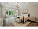 Bright main bedroom has dark hardwood floors, sitting area, and tray ceilings at 300 Wheatberry Hill Dr, Weddington, NC 28104