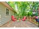 Wooden deck with colorful chairs offers a cozy outdoor seating area, perfect for enjoying the tranquil backyard at 3043 Charles Rd, Shelby, NC 28152