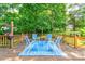 A backyard with a wooden deck featuring a blue patterned rug with a seating area for backyard entertainment at 3043 Charles Rd, Shelby, NC 28152