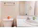Bathroom featuring a toilet, sink, and a mirror with lighting at 3043 Charles Rd, Shelby, NC 28152