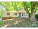 Charming single-story home with a covered front porch and well-maintained landscaping beneath the shade of mature trees at 3043 Charles Rd, Shelby, NC 28152