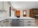 Stylish kitchen island with marble countertop, stainless steel dishwasher, and view of the cozy brick fireplace at 3043 Charles Rd, Shelby, NC 28152