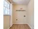 Bright laundry room with window and functional shelving for easy storage at 3043 Charles Rd, Shelby, NC 28152