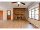 Inviting living room featuring a brick fireplace and newer vinyl plank flooring at 3043 Charles Rd, Shelby, NC 28152