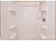 All-white shower stall showcasing the shower head and built-in shelving at 3043 Charles Rd, Shelby, NC 28152