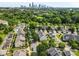 Residential neighborhood aerial showing houses with mature trees and a distant city skyline at 3153 Bending Birch Pl, Charlotte, NC 28206