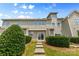 Townhouse backyard with lush green grass, landscaping, and direct access to the upper units at 3153 Bending Birch Pl, Charlotte, NC 28206