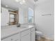 Bathroom features a sink with white cabinets, a mirror, and a toilet at 3153 Bending Birch Pl, Charlotte, NC 28206